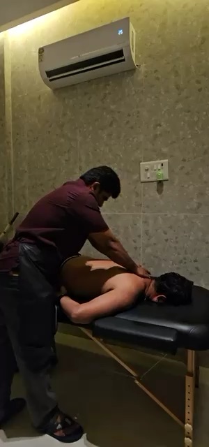 A therapist working on a client's back during a massage session at NS Wellness Massage Therapy in Nerul