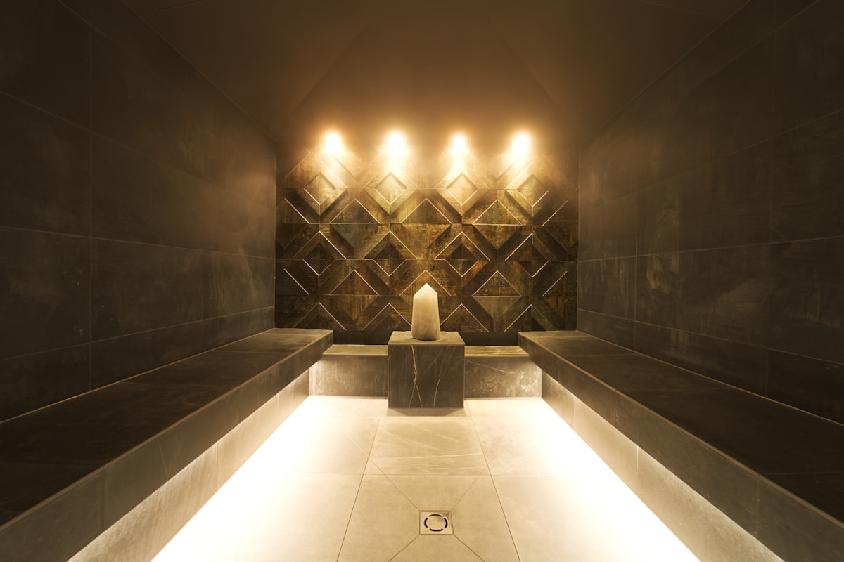 A candlelit spa interior with still water and soft reflected light